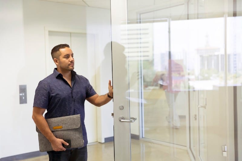 Man entering room with case