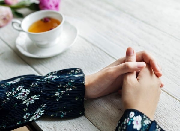 Hands and tea on desk