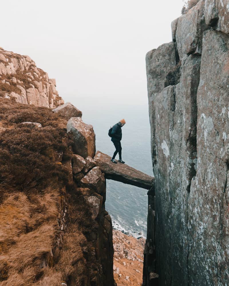 Man walking between boulders