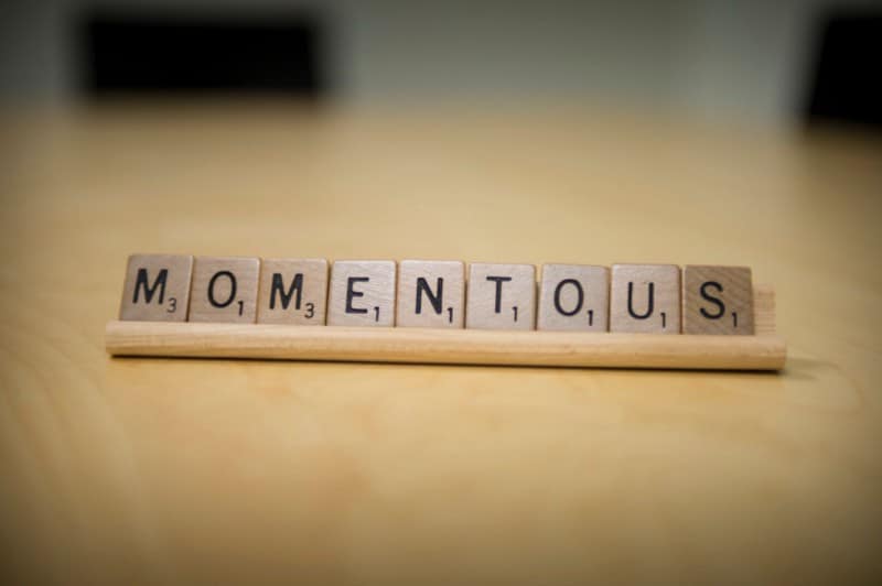 Scrabble tiles spell Momentous
