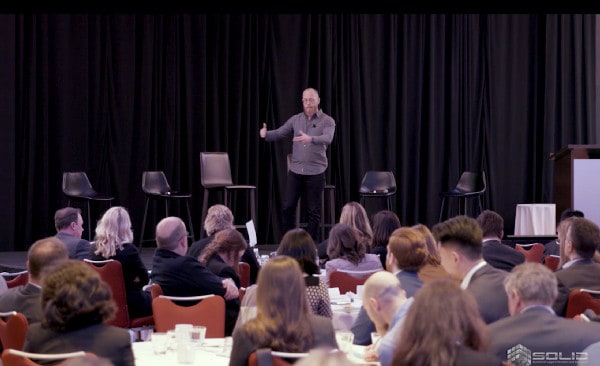 Douglas speaking on stage