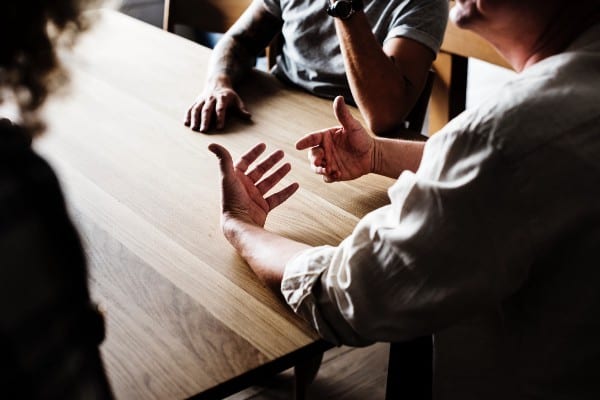 Hands talking at a table