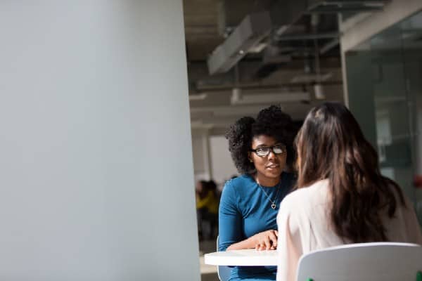 Two people discussing at a table
