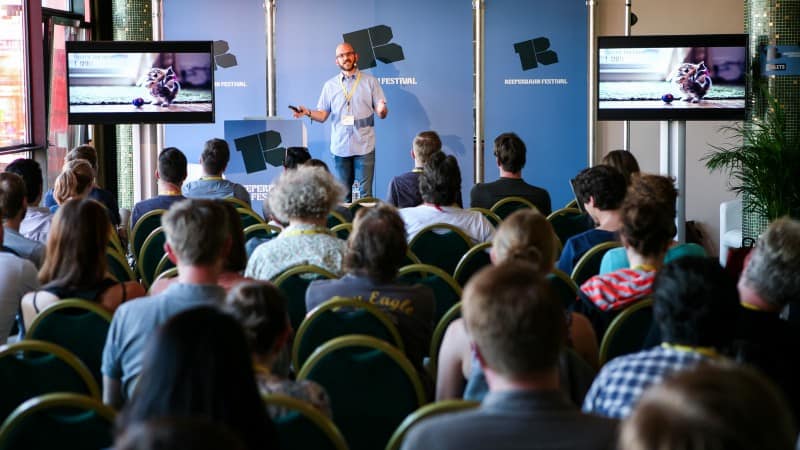Jeff speaking in a crowded room