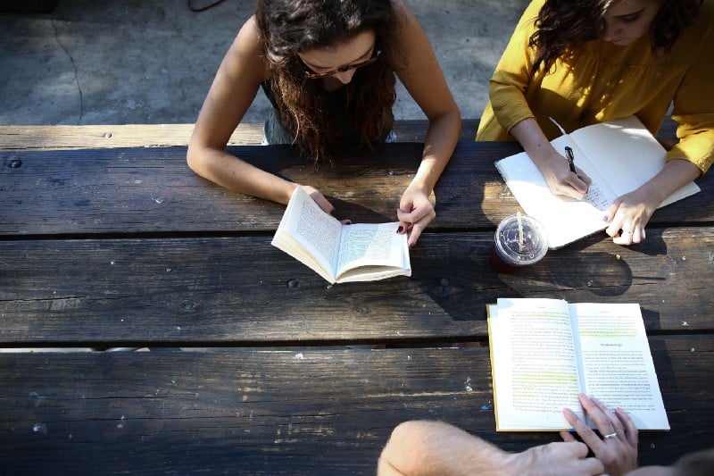 People reading at a table