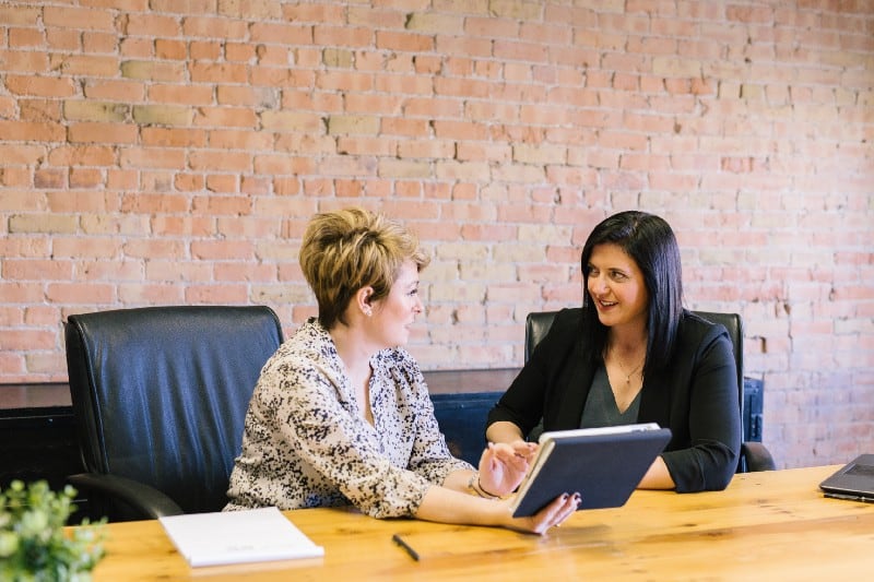 Two women discussing a project