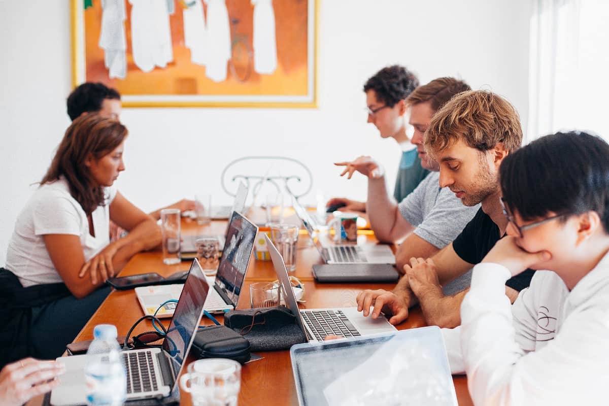 Meeting at table with laptops