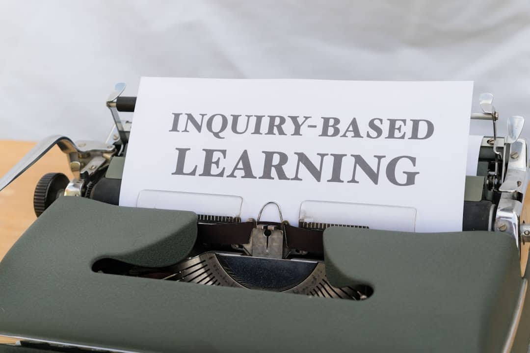 a close up of a typewriter with an inquiry - based learning sign - AI fluency framework
