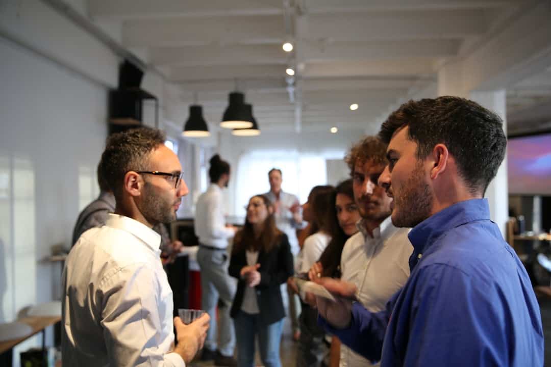 a group of people standing in a room - ai transformation vs digital transformation
