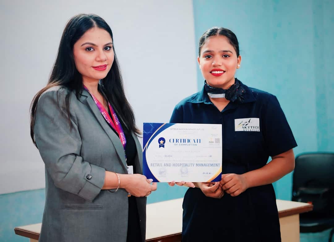 Two women holding a certificate - certification in change management