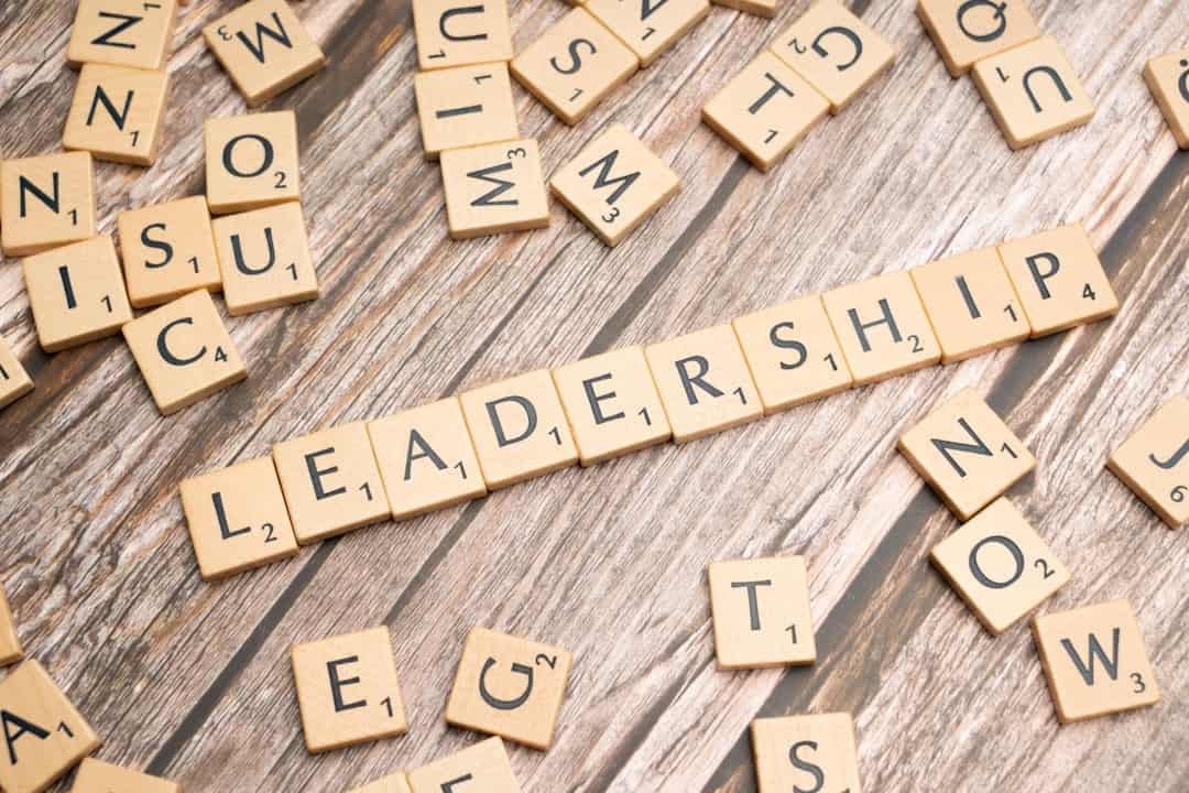 scrabble tiles spelling out the word leadership on a wooden surface - ai transformation leader