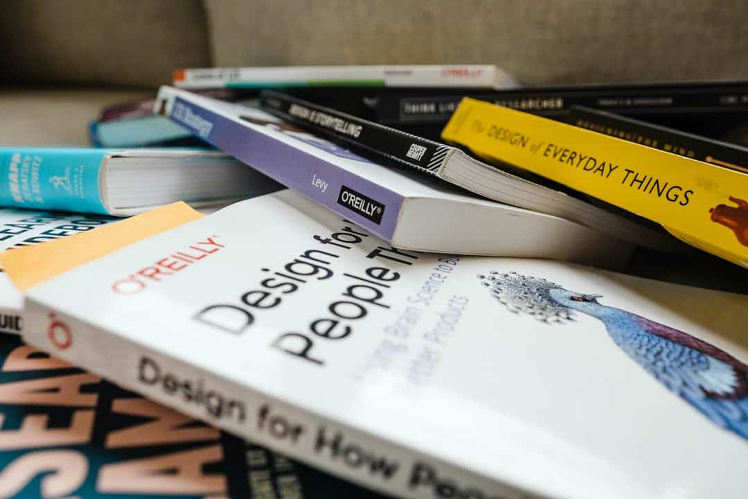white and green labeled book - design thinking ai adoption