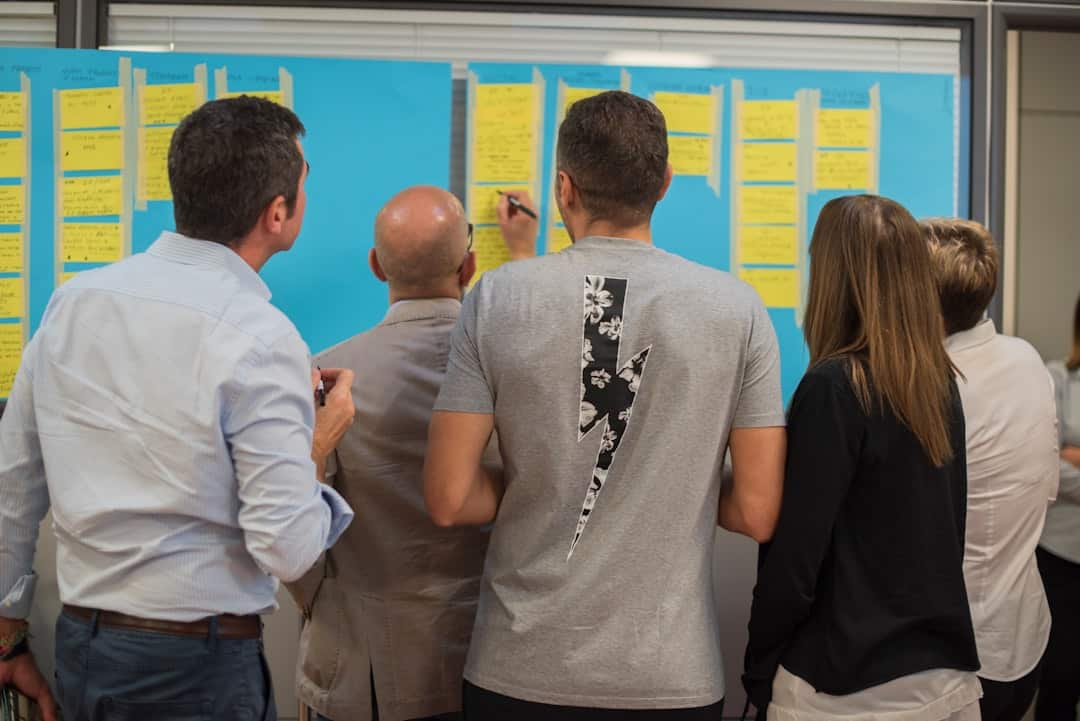 man in white dress shirt standing beside woman in black shirt - cross-functional ai alignment workshop